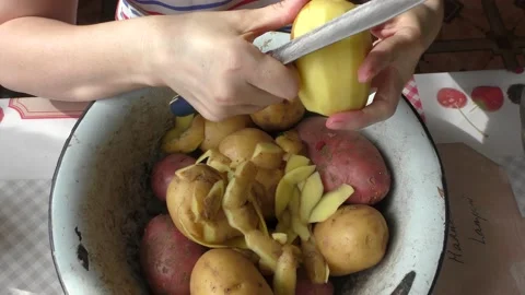 The cook peels the potatoes Stock Footage 154846795
