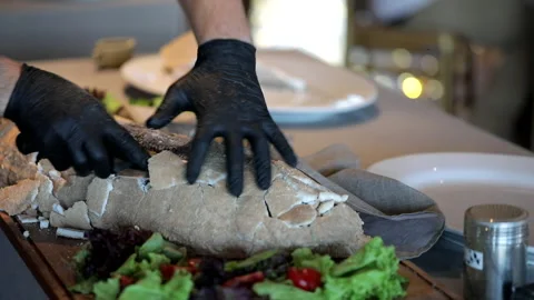 The cook performs and shows baked fish in salt Stock Footage 253396438