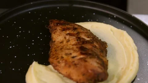 A cook places chicken on mashed potatoes. Slow motion. Stock Footage 303745309