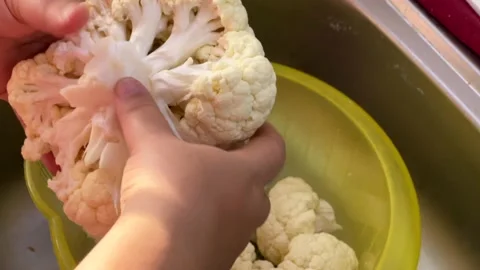 Cook portioning cauliflower freshly bought from the market Stock Footage 166648362