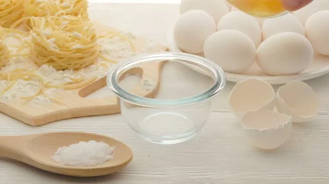 Cook pour an egg into the bowl Stock Footage 62064186