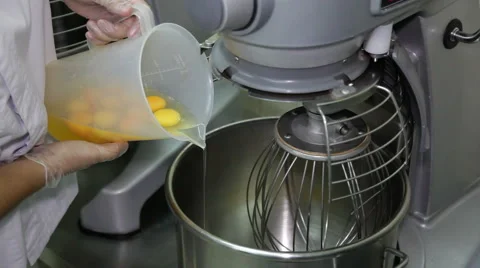 Cook Pouring the Eggs into the Mixer. Stock Footage 66422085