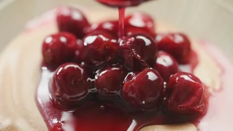 The cook pouring syrup over eggless chocolate mousse with sour cherry compote. Stock Footage 194921333