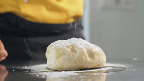 Cook pours flour on the dough Stock Footage 127969264