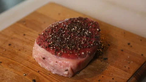 Cook pours out black pepper panes beef steak Stock Footage 91270802