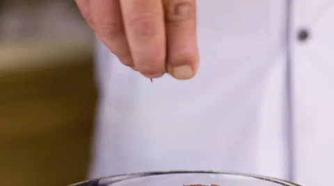 Cook pours spices Stock Footage 49230011