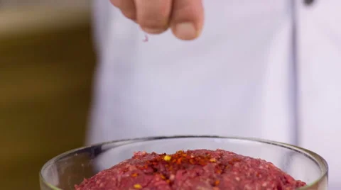 Cook pours spices Stock Footage 49274547