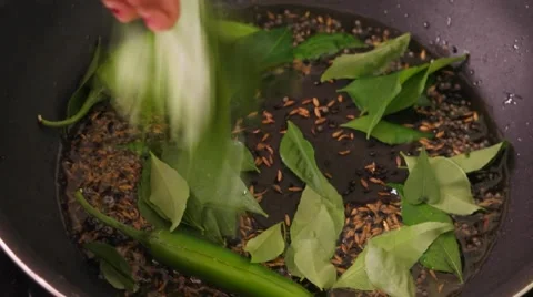 Cook prepares the base for a Indian masala mix with curry leaf Video stock 62828545