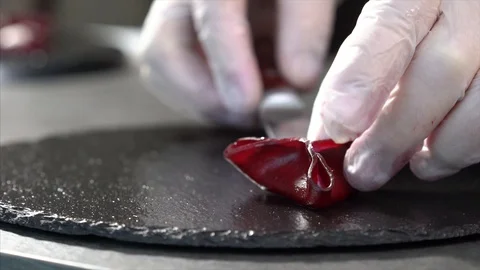 Cook prepares beetroot appetizer. The cook puts a beetroot snack on a plate Stock Footage 126447123
