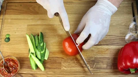 Cook prepares canapes in the kitchen, cutting tomato Stock Footage 64052391