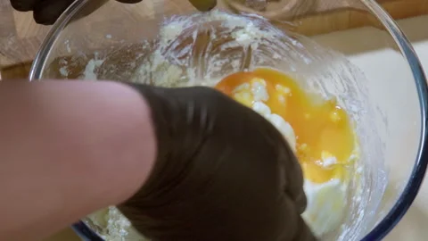 A cook prepares cookie dough. Egg cottage cheese, flour, sugar, butter. Stock Footage 301235968