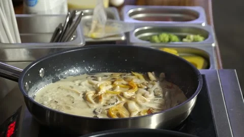 Cook prepares the dish in a boiling pan Stock Footage 148314791