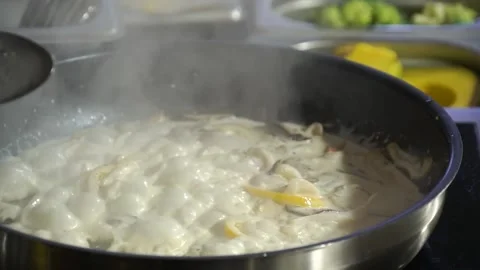 Cook prepares the dish in a boiling pan Stock Footage 148314793