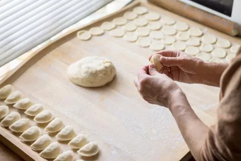 Cook prepares dumplings Stock Photos
