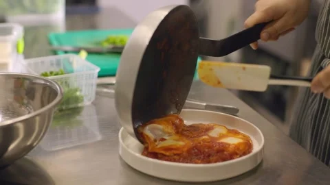 The cook prepares fried scrambled eggs in a frying pan. Stock Footage 277131610