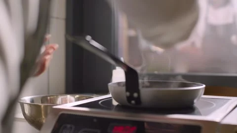The cook prepares fried scrambled eggs in a frying pan. Stock Footage 277131662