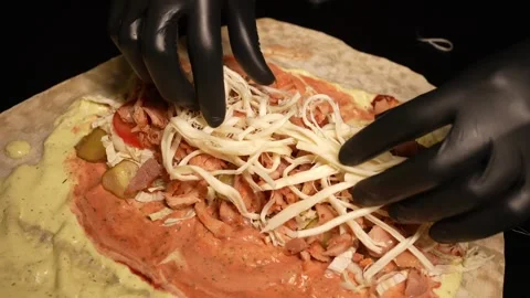 The cook prepares it in black gloves Stock Footage 241693573