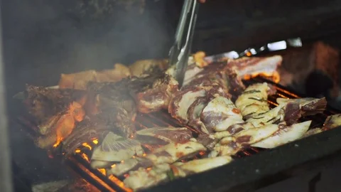 The cook prepares lamb meat on the grill, in slow motion Stock Footage 74307215