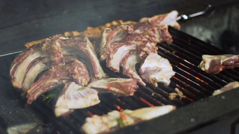 The cook prepares lamb meat on the grill, in slow motion Stock Footage 74307523