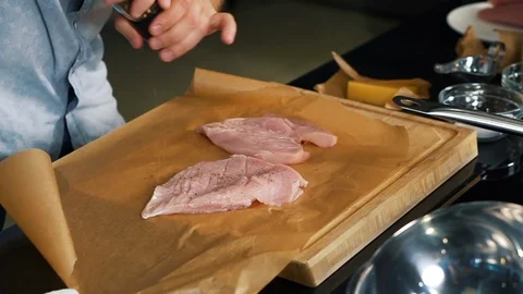 Cook prepares meat, delicious steak recipe, two pieces of meat on cutting board Stock Footage 122903444