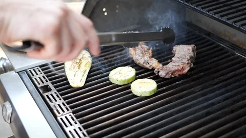 The cook prepares the meat on the grill Stock Footage 116769431