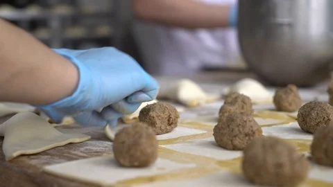 Cook prepares meat pies Stock Footage 128692181