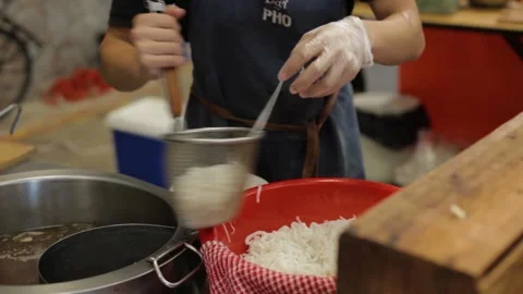 Cook Prepares Noodles with Strainer at Indoor Food Stall in Sydney Market Stock Footage 345702292