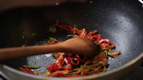 Cook Prepares Pasta On Stove, Quickly Stirring With Spoon, Closeup Stock Footage 83590941