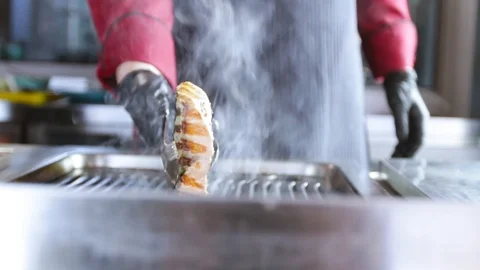 Cook prepares salmon on the grill Stock Footage 109471278
