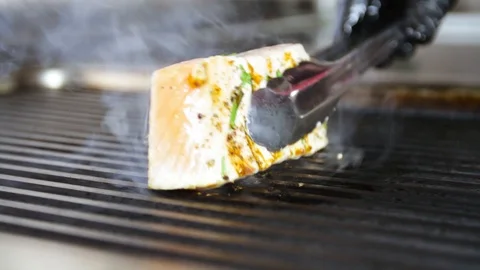 Cook prepares salmon on the grill Stock Footage 109471279
