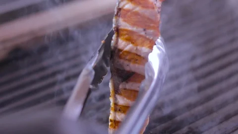 Cook prepares salmon on the grill Stock Footage 109471385