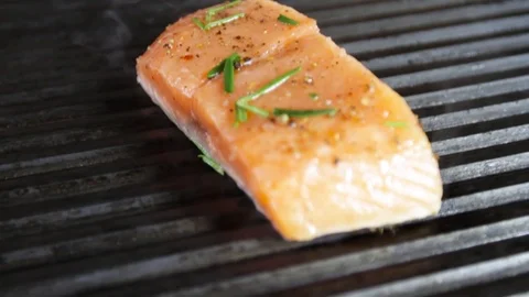 Cook prepares salmon on the grill Stock Footage