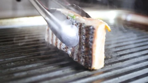 Cook prepares salmon on the grill Stock Footage 109471428