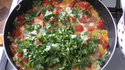 The cook prepares scrambled eggs with vegetables. healthy food concept Stock Footage 161695698