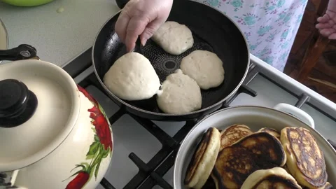 The cook prepares small pancakes in a frying pan. healthy food concept Stock Footage 197018853