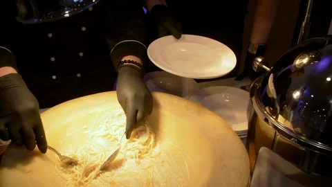The cook prepares spaghetti in cheese. Stock Footage 121894587