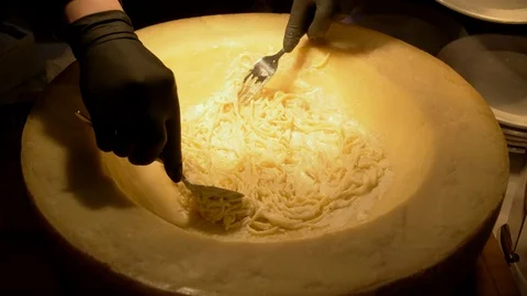 The cook prepares spaghetti in cheese Stock-Footage 121895544