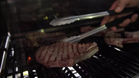 The cook prepares a steak on the grill Stock Footage 221363279