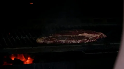 The cook prepares steaks on the grill Stock Footage 125889829