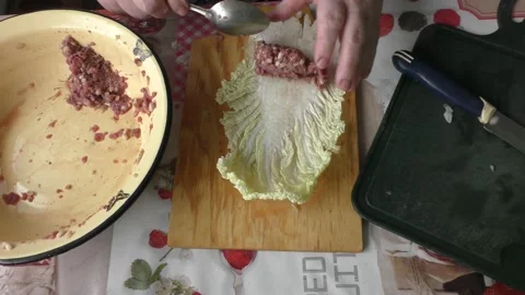 The cook prepares stuffed cabbage rolls from deer meat.  healthy food concept Stock Footage 155070451
