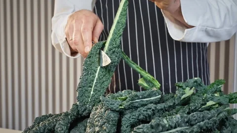 The cook prepares Tuscan cabbage cale nero, cavolo nero, Lacinato kale. Stock Footage 305385940