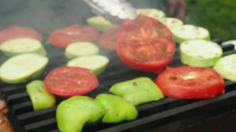 The cook prepares vegetables with meat on the grill.roasting on the fire. 4K Stock Footage 134901880