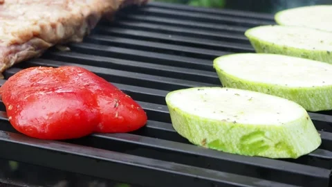 The cook prepares vegetables with meat on the grill.roasting on the fire. 4K Stock Footage 134901889