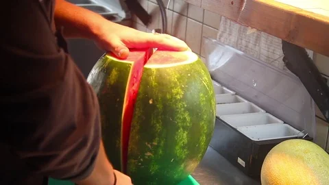 The Cook prepares a watermelon 스톡 동영상 72334629