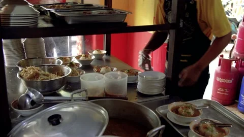 A cook preparing and bringing fresh meat soup (soto daging) Stock Footage 208838483