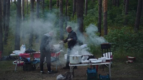 The cook is preparing a barbecue in the forest Stock Footage 201427641