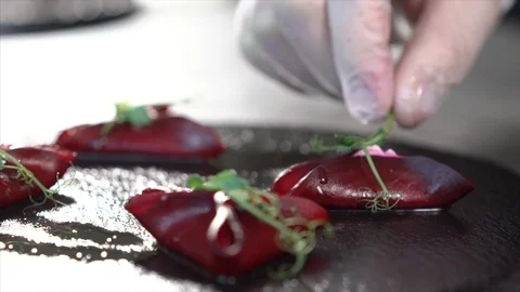 The cook is preparing a beetroot appetizer. Decorates the dish Stock Footage 126447351