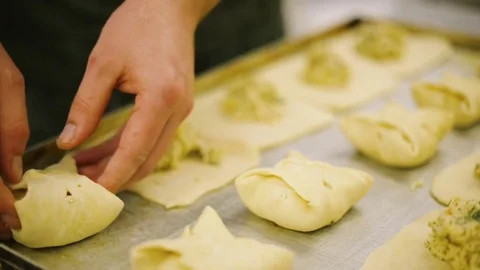 Cook preparing buns with cheese Stock Footage 69778782