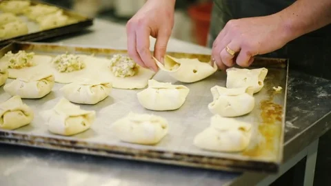 Cook preparing buns with cheese Stock Footage 69937497