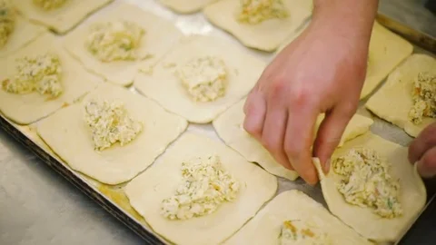 Cook preparing buns with cheese Stock-Footage 69937985